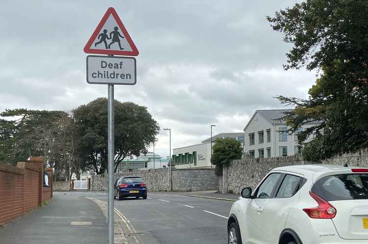 Image: Photo of cars moving outside the Deaf Academy