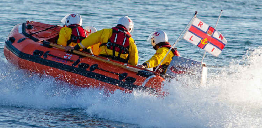 Exmouth RNLI Inshore Lifeboat attending the rescue.