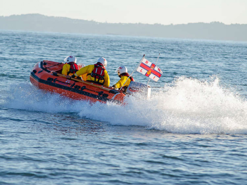 Exmouth RNLI Inshore Lifeboat speeds to the rescue. Credit:  John Thorogood / RNLI