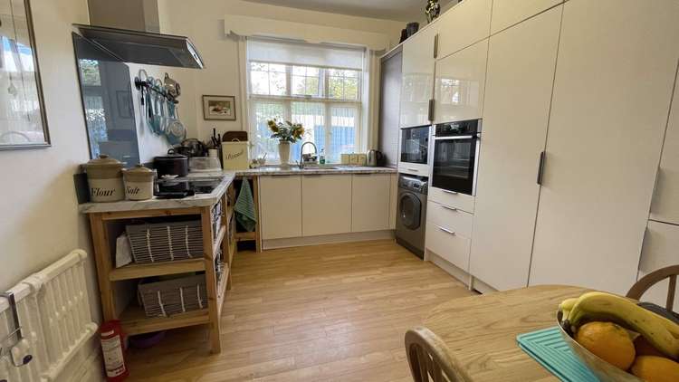 There is a modern kitchen with built-in appliances including a hob, fan-assisted oven, microwave, fridge/freezer and dishwasher. Credit: Whitton & Laing