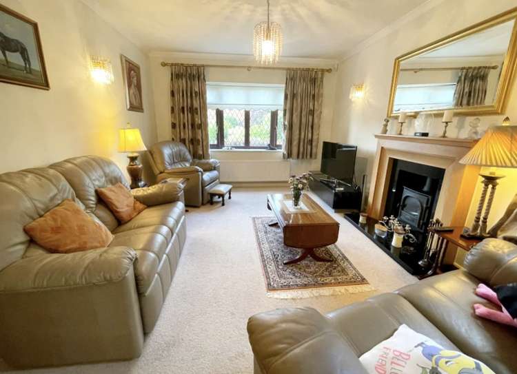 The sitting room has a front window and stove. Credit: Whitton & Laing