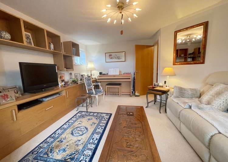 The living room is bright and spacious with a front-facing bay window