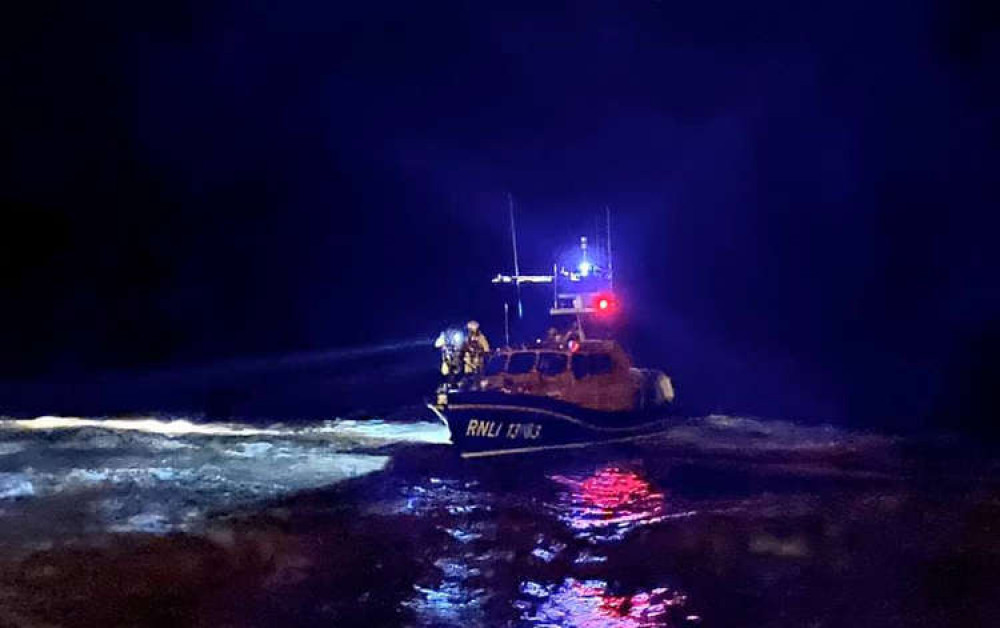 Exmouth RNLI all weather lifeboat engaged in a search at night. Credit: Eddie Holden