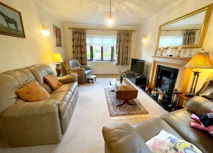 The sitting room has a front window and stove. Credit: Whitton & Laing