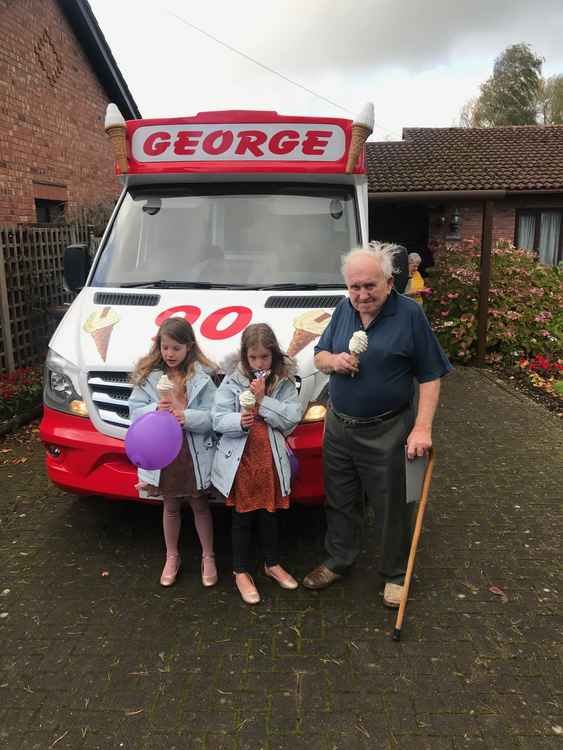 Birthday boy George with granddaughters, Jasmine and Willow, next to his special delivery.