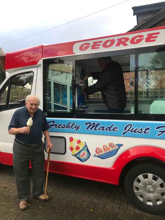 George tucks into an ice cream.