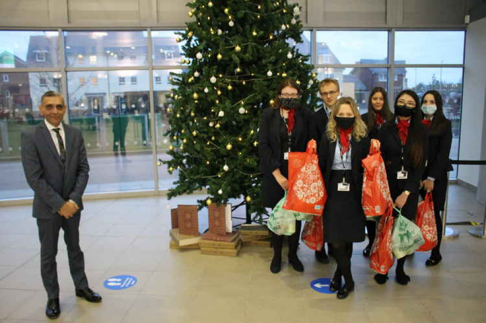 Principal and CEO of Cheshire College South & West Dhesi with Travel & Tourism learners collecting their hampers