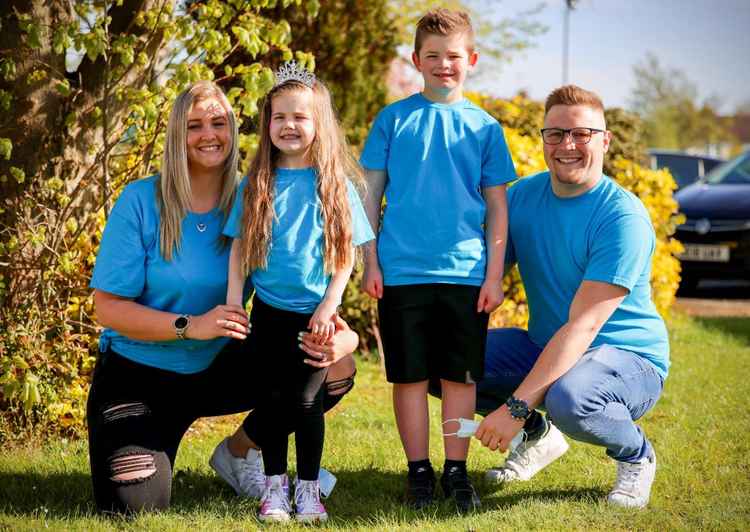 Acacia, pictured with her brother Landon, mum Carly and stepfather Ben.