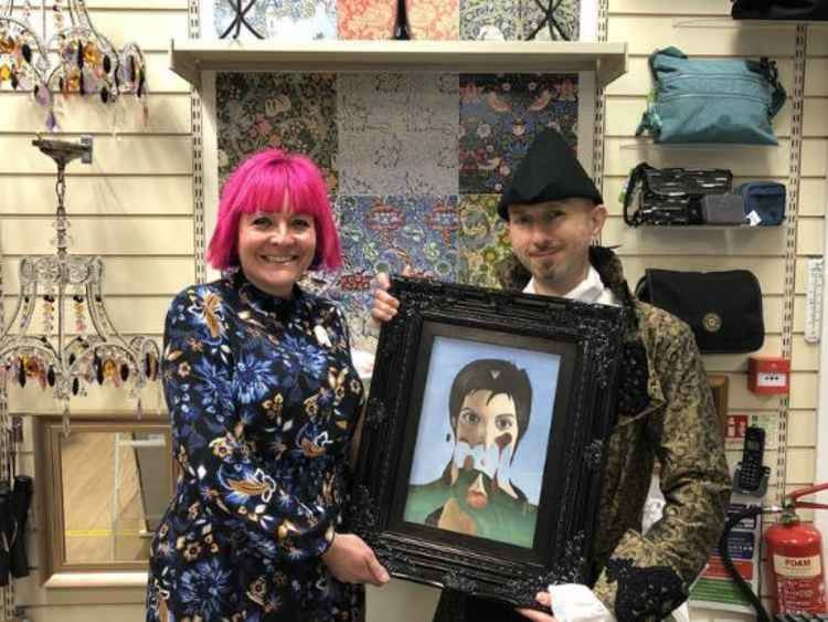 Mark Sheeky hands over his Liza Minelli oil painting to the Barnado's art gallery.