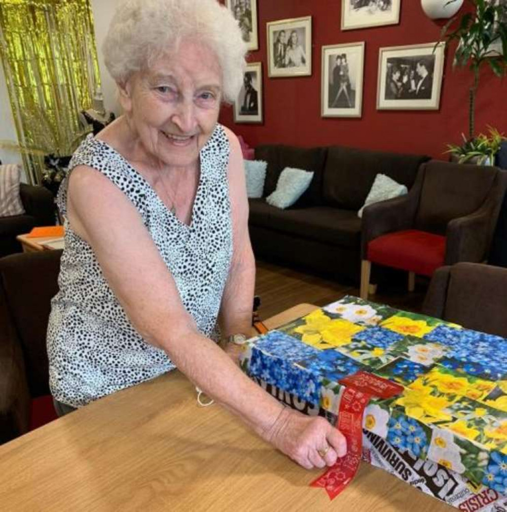 Belong resident Margaret Jackson helps to seal the care village's memory box.