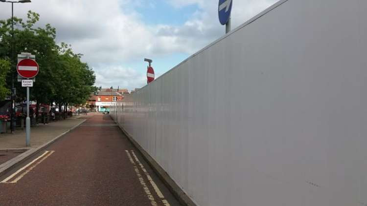 The bland hoardings, here in Victoria Street, look unsightly.