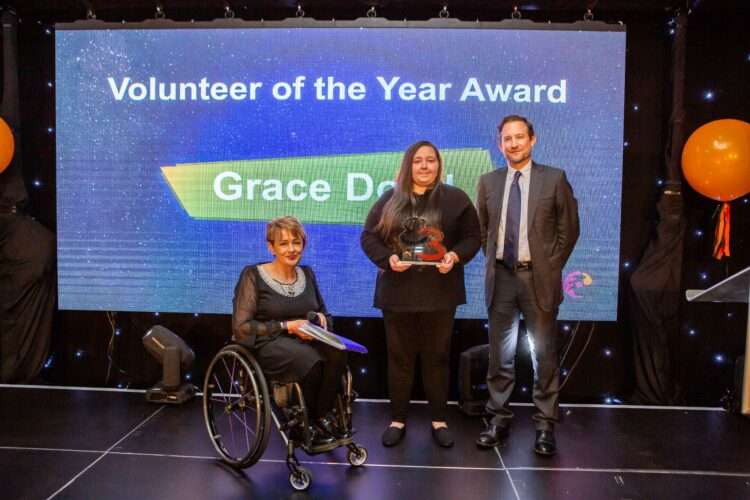 Grace Dodd receives the Volunteer of the Year Award from Charlie Miller at Bates Wells and Baroness Tanni Grey-Thompson.