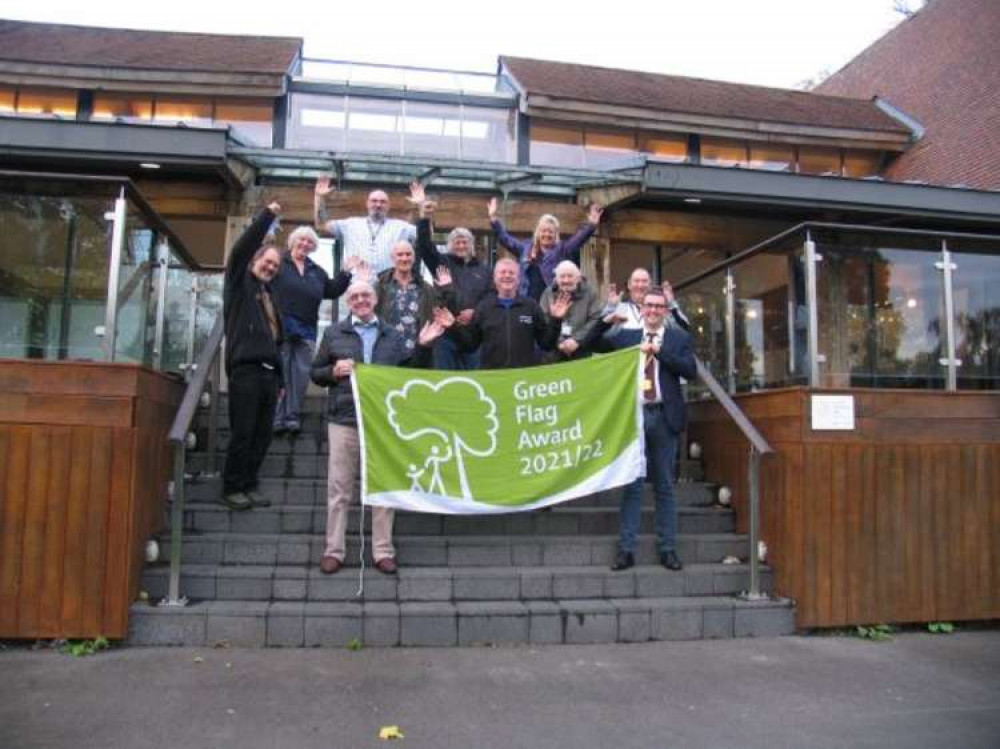 Staff and volunteers celebrate the Green Flag Award at Queens Park.