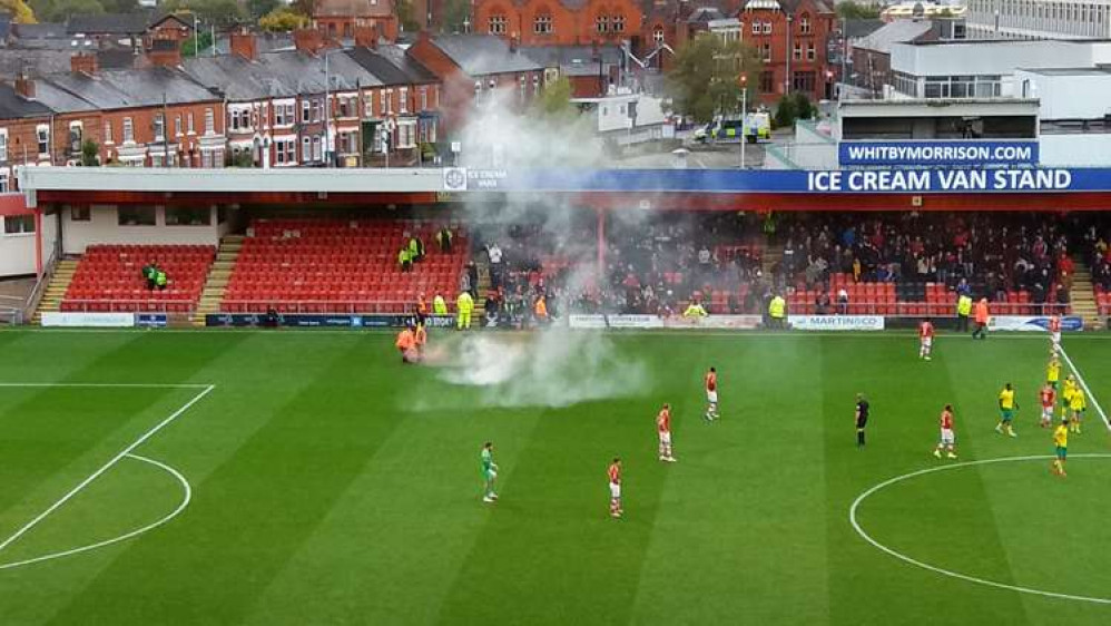 Flares go off as Swindon fans celebrate taking the lead at the Mornflake Stadium this afternoon.