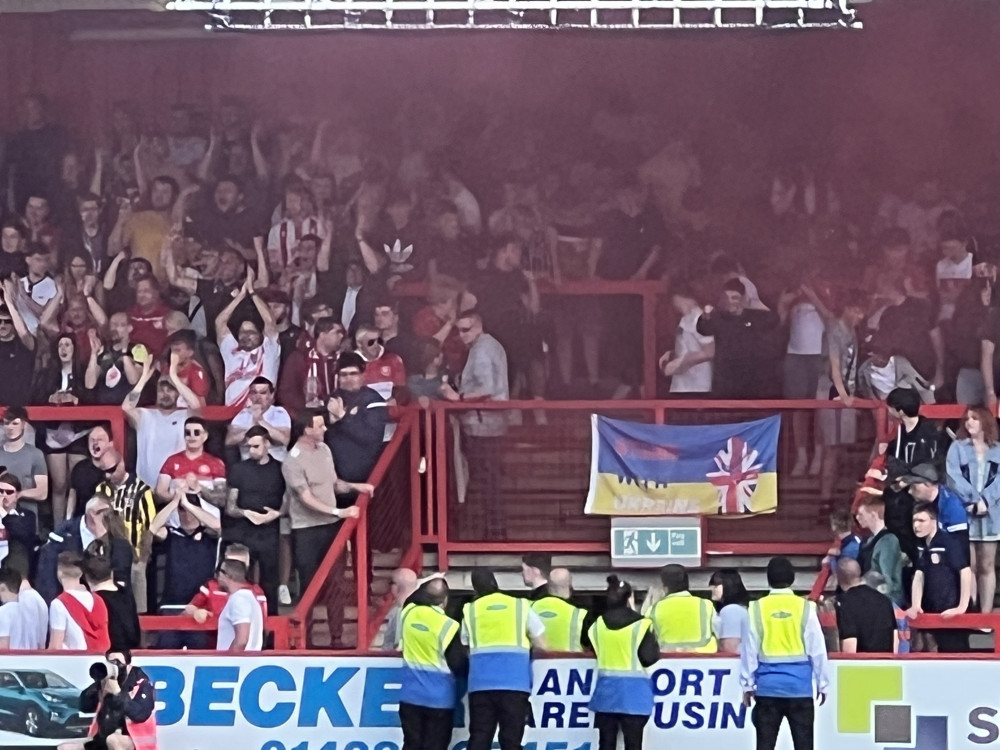 Stevenage fans on the East Terrace celebrate after Boro's 1-0 victory over Rochdale on Good Friday at the Lamex. CREDIT: @laythy29 