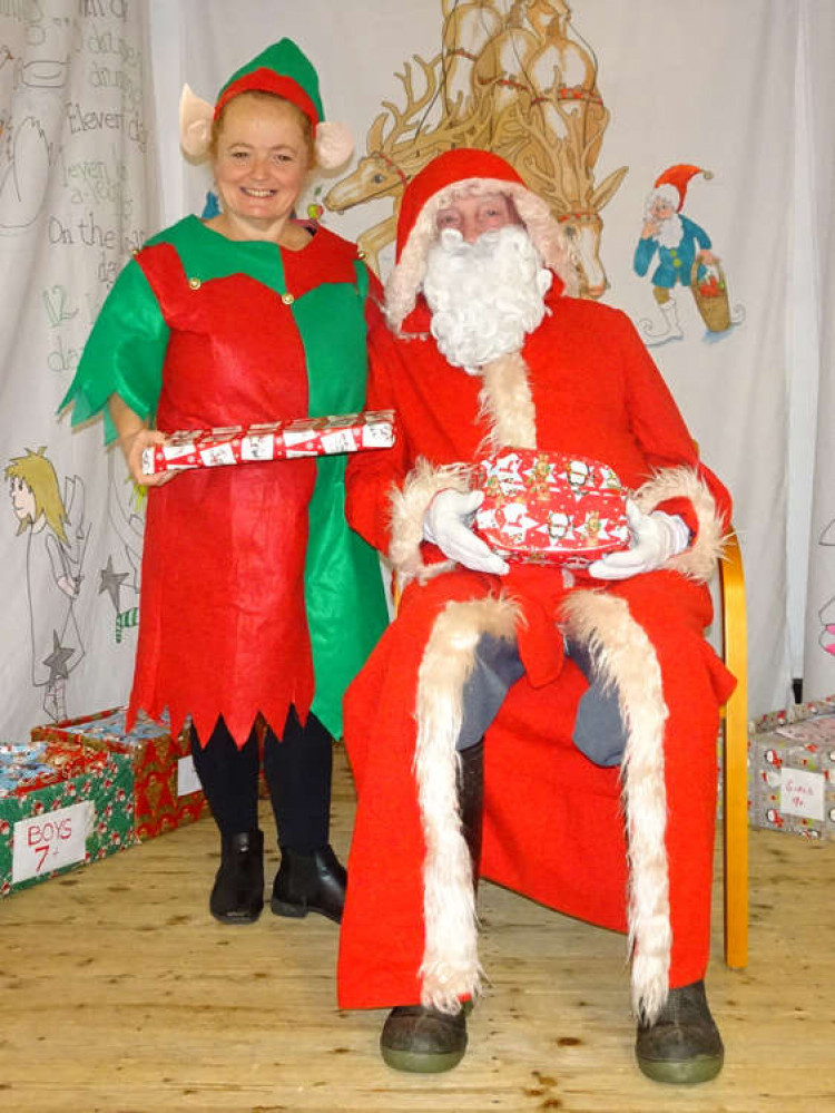 Father Christmas and an elf helper at Wistaston Memorial Hall's Cancer Research UK Christmas Fair (Picture: Jonathan White).