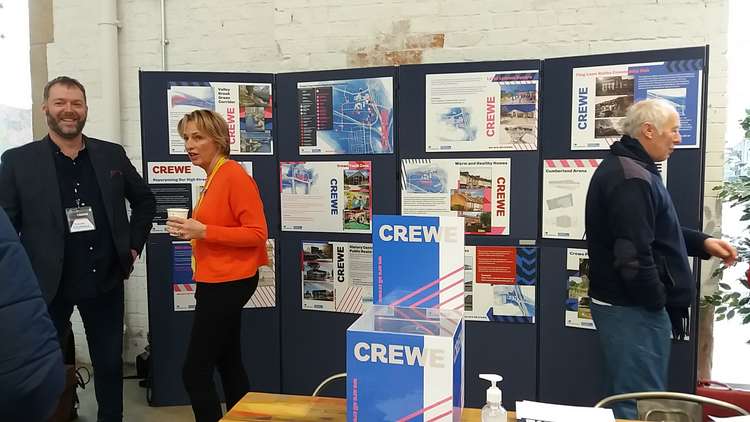 Chairman of Crewe Town Board Doug Kinsman (left) in front of the projects display at Crewe Market Hall.