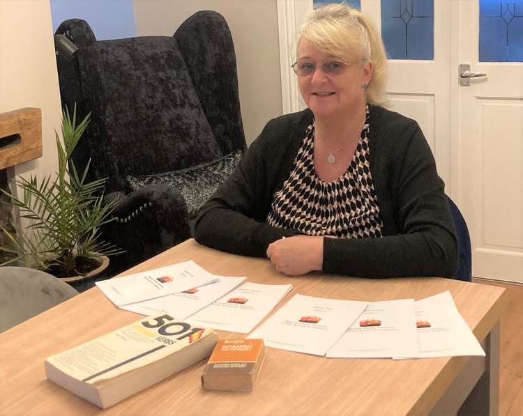 Angela with her Spanish course materials.