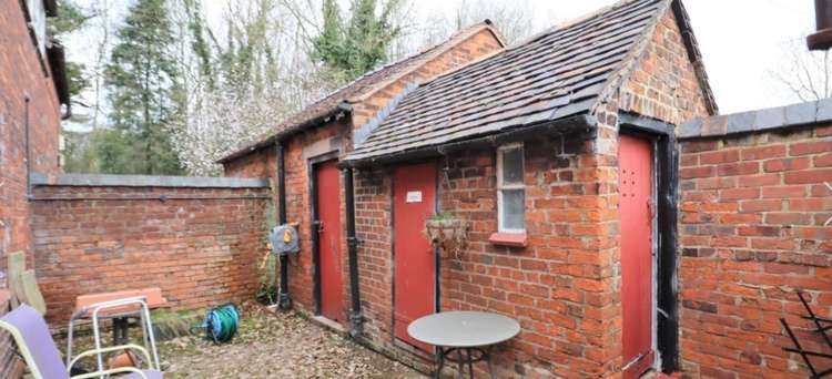 There are outhouses with a potting shed and WC.