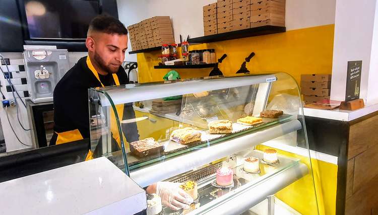 Business owner Mr Abbat Ahmed picking up one of his cakes.
