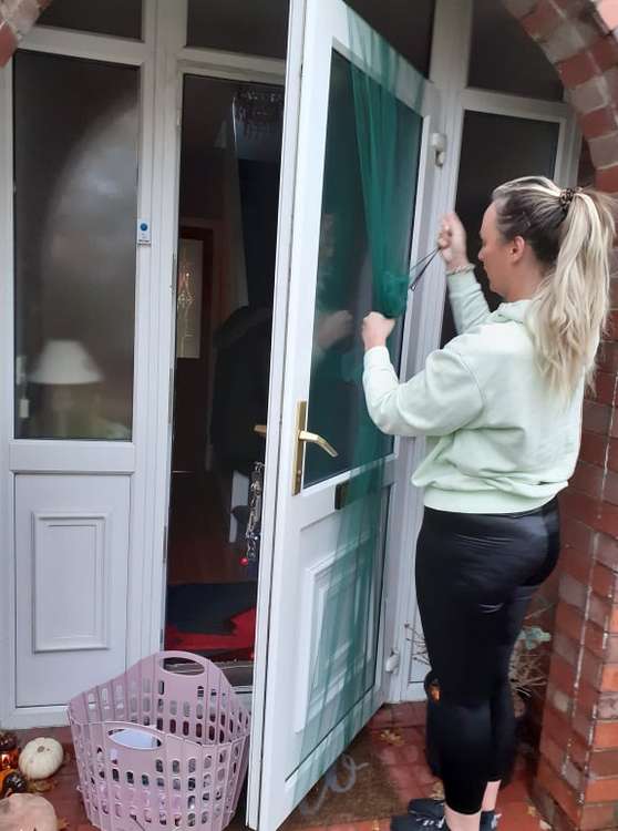 Abigail at work on a front door.