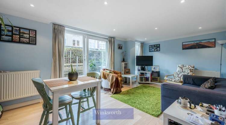 The bright reception room that leads out to the property's private patio (credit: Winkworth)