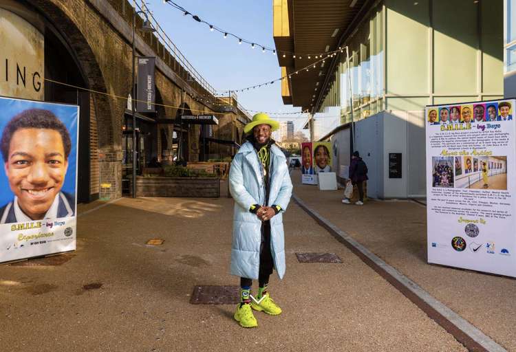 Kay Rufai with the portraits at Battersea Power Station (credit: Battersea Power Station)