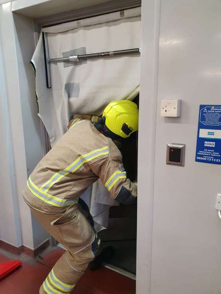 A Carlton firefighter demonstrating a smoke curtain. Photo courtesy of Nottinghamshire Fire and Rescue Service.