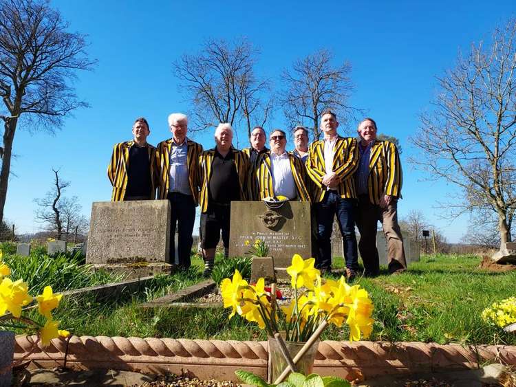 Letchworth Rugby Club Gravefinders team pays tribute to Second World War hero and England International: RAF Flight Lieutenant Brian McMaster. PICTURE: Letchworth Rugby Club Gravefinders team at the grave of Second World War hero and England International