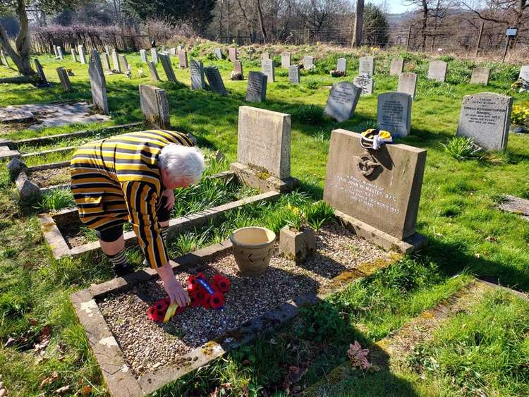 Letchworth Rugby Club Gravefinders team pays tribute to Second World War hero and England International: RAF Flight Lieutenant Brian McMaster. PICTURE: Letchworth Rugby Club Gravefinders team at the grave of Second World War hero and England International