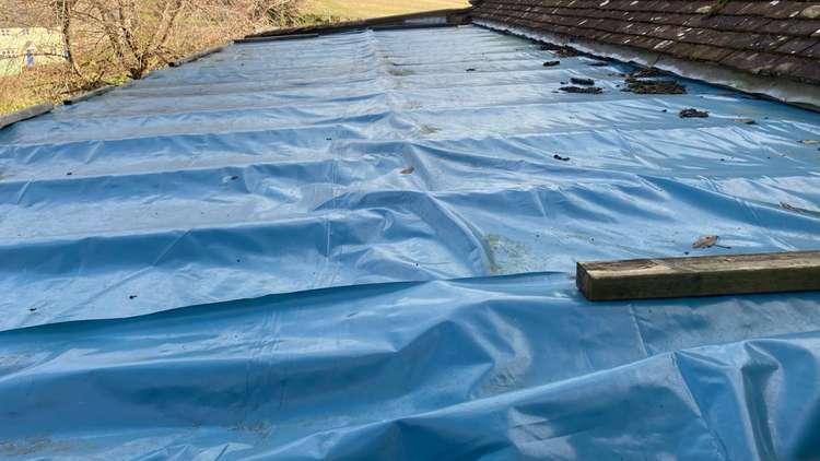 The north aisle remains under blue tarpaulin