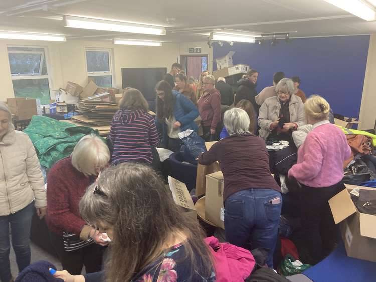 Volunteers sorting through donations at The Prince of Wales School