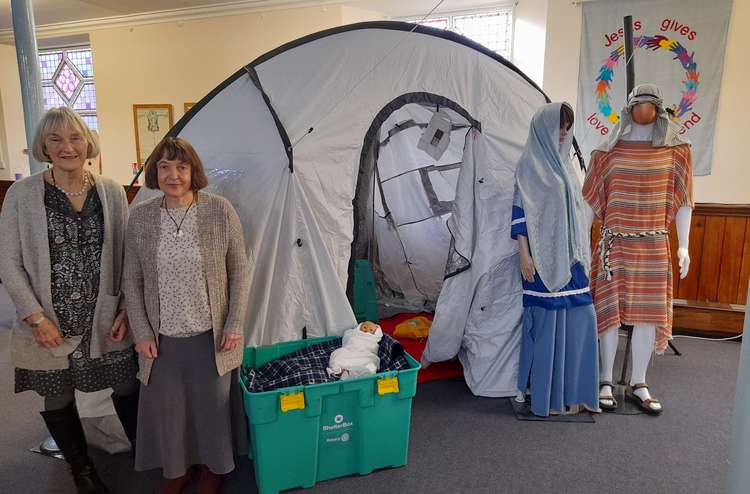 Jan Dicks and Claire Coster with a Shelter Box and Jesus with Mary and Joseph (picture credit: HURC