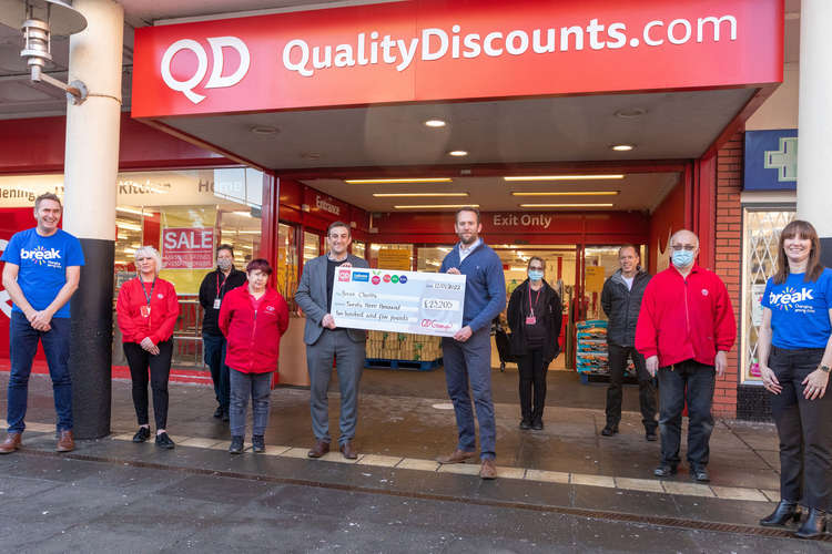 Karl Ottolangui, QD's operations director, presenting the funds raised to Dan Crouch, director of income generation at Break. From left to right; Peter Marron (corporate fundraising and project manager - Break) with QD team members Lu Crane, Jo Grief, S