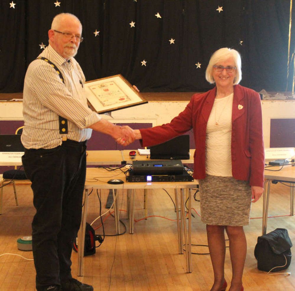 Former councillor Susan Spiller receives a certificate for the Honorary Freedom of the Parish of Axminster from Cllr Jeremy Walden