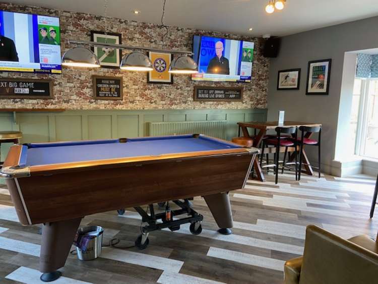 As well as a local pub feel, it also has a sports bar area. Photo Credit: Tom Surgay