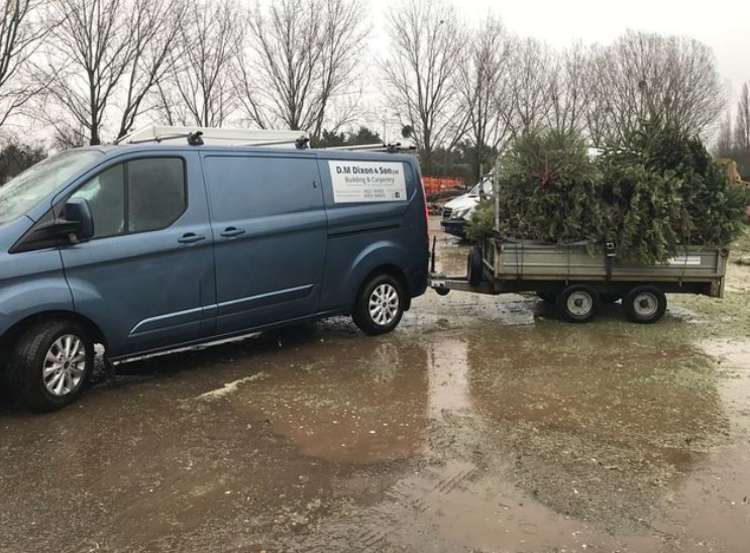 D F Clark helping with Christmas tree recycling