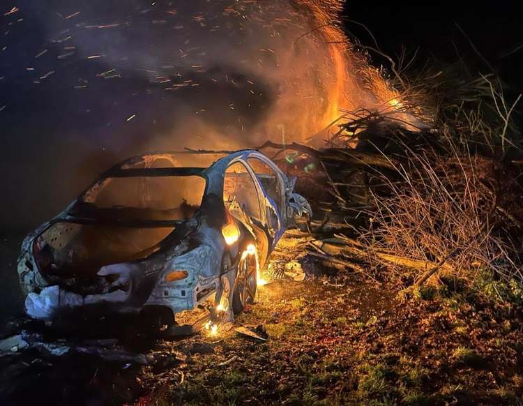 The car was positioned close to a wood stack, which was also alight (Photo: Essex County Fire and Rescue Service)