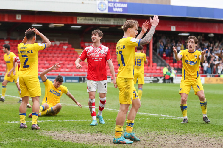 Delight for Chris Long and despair for AFC Wimbledon's players after Crewe's second (Picture credit: Kevin Warburton).