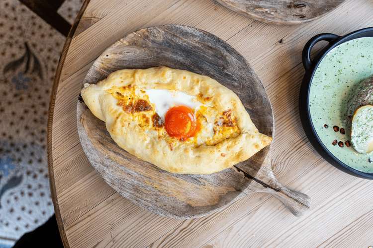 Ajaruli Khachapuri, baked bread filled with cheese, topped with egg and butter (Image: The Georgian)