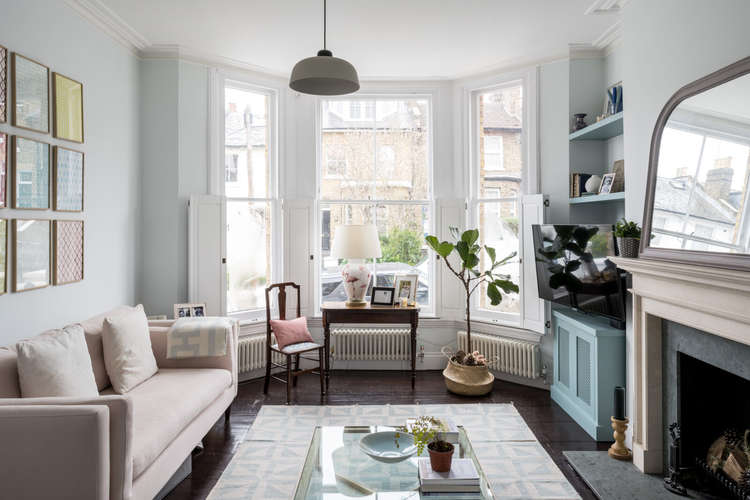 The impressive living space is painted in Farrow & Ball's soft blue 'Cabbage White' (Image: The Modern House)