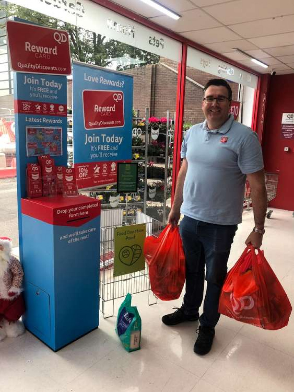 Paul Williams, captain at The Salvation Army, Basildon, collecting the food bank donations from QD Basildon.