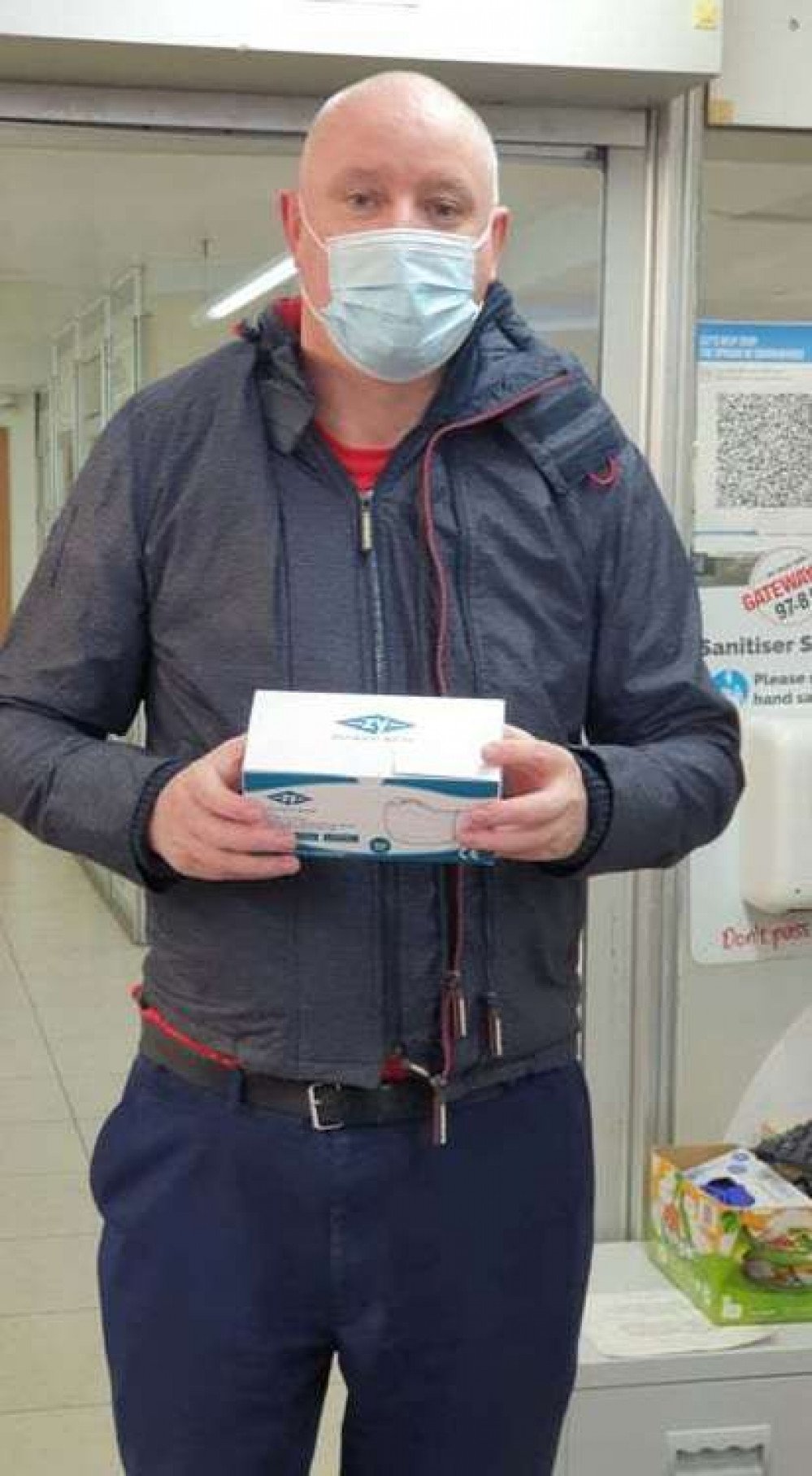 Chairman of the Licensing Committee Cllr Danny Lawrence with one of the boxes of face masks.