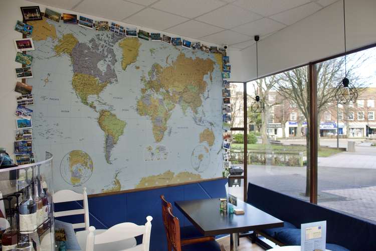 Postcards and world map on the wall inside (Nub News, Will Goddard)