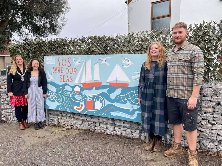 The unveiling of the mural, Kirstie Edwards with Rosie, Holly and Teddy from Creative Falmouth.