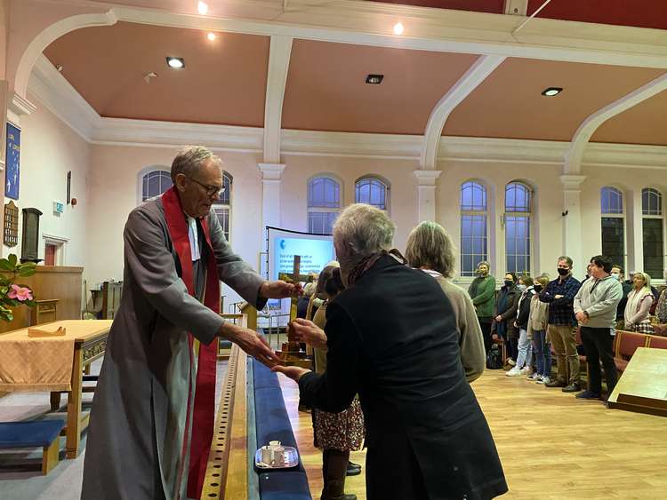 Rev Andrew Mumford handing over items from the church to symbolise "moving on".