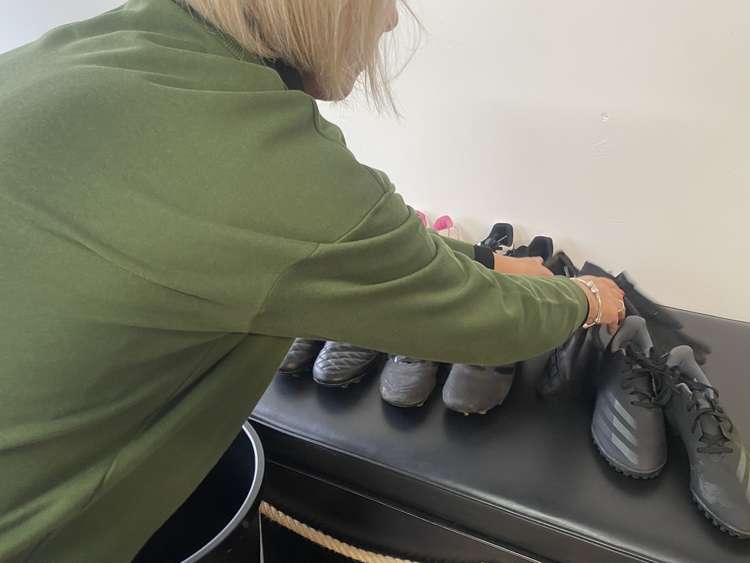 Sarrelle McCann, owner of Boslowick Barbers, putting out the boots.