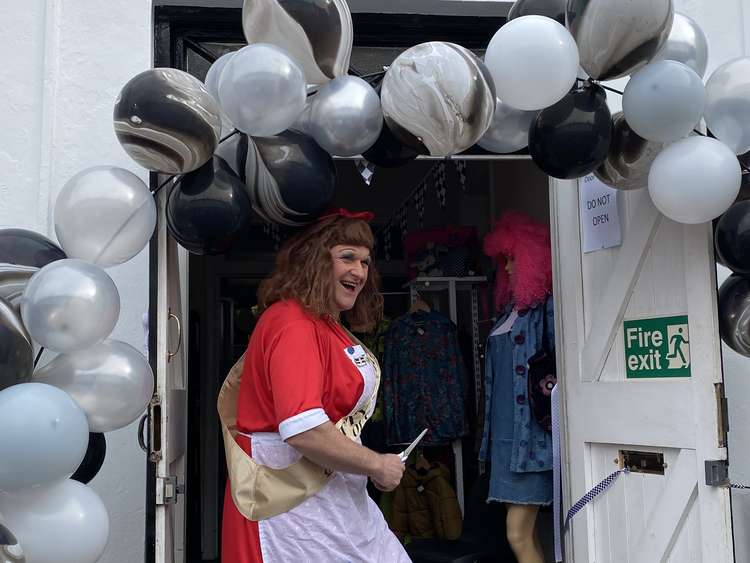 Betty Stogs cutting the ribbon, officially opening the Penryn charity shop.