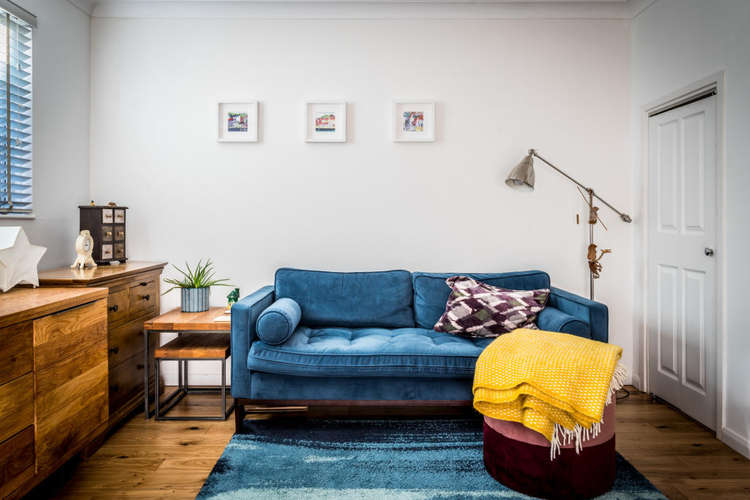 A sapphire blue sofa adds a touch of colour (Image: Carringtons)