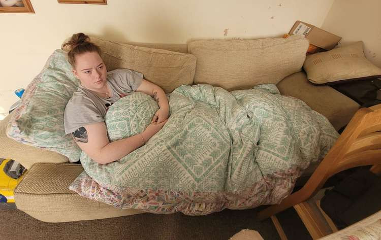 Mollie Harman has pulled muscles in her back from sleeping on the sofa (Credit: Melissa Cook)